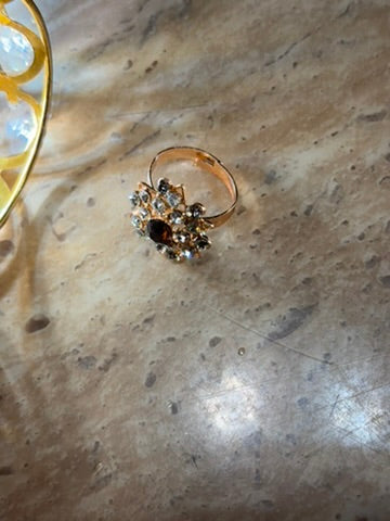 STONE RING IN BROWN COLOUR .