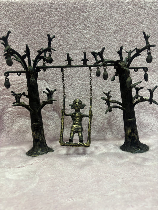 Z .ANTIQUE FORM STATUE OF A KID ON SWING WITH TREES