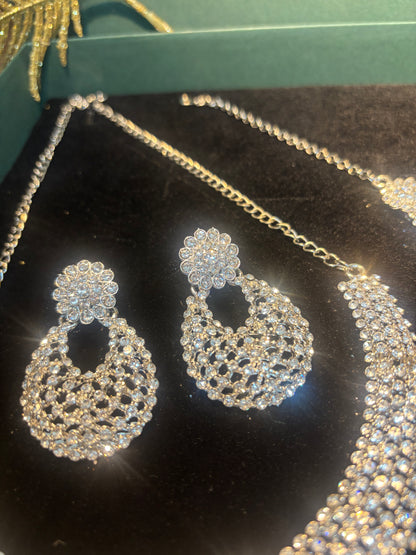 MAGNIFICENT SIVLER STONE NECKLACE IN SLEEK CHOKAR PATTERN WITH EARRING AND TIKA