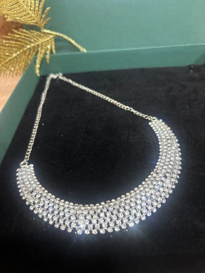 MAGNIFICENT SIVLER STONE NECKLACE IN SLEEK CHOKAR PATTERN WITH EARRING AND TIKA